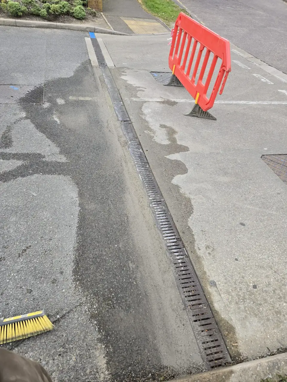 New linear channel drain installed across a road crossing