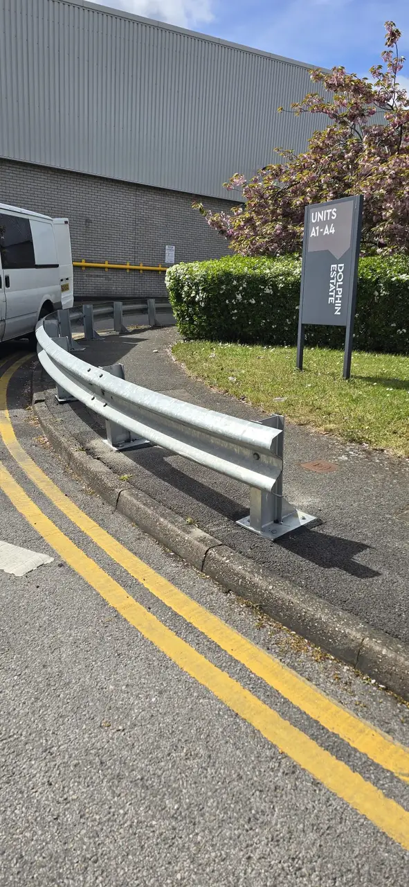 Curved armco safety barrier installed on an industrial estate