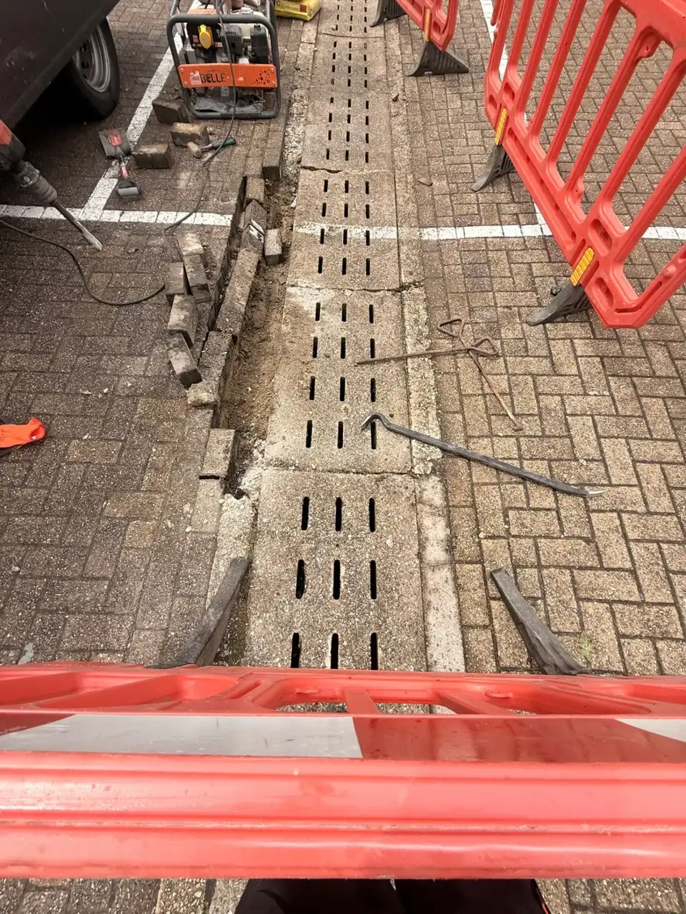Block paving lifted for channel drain replacement